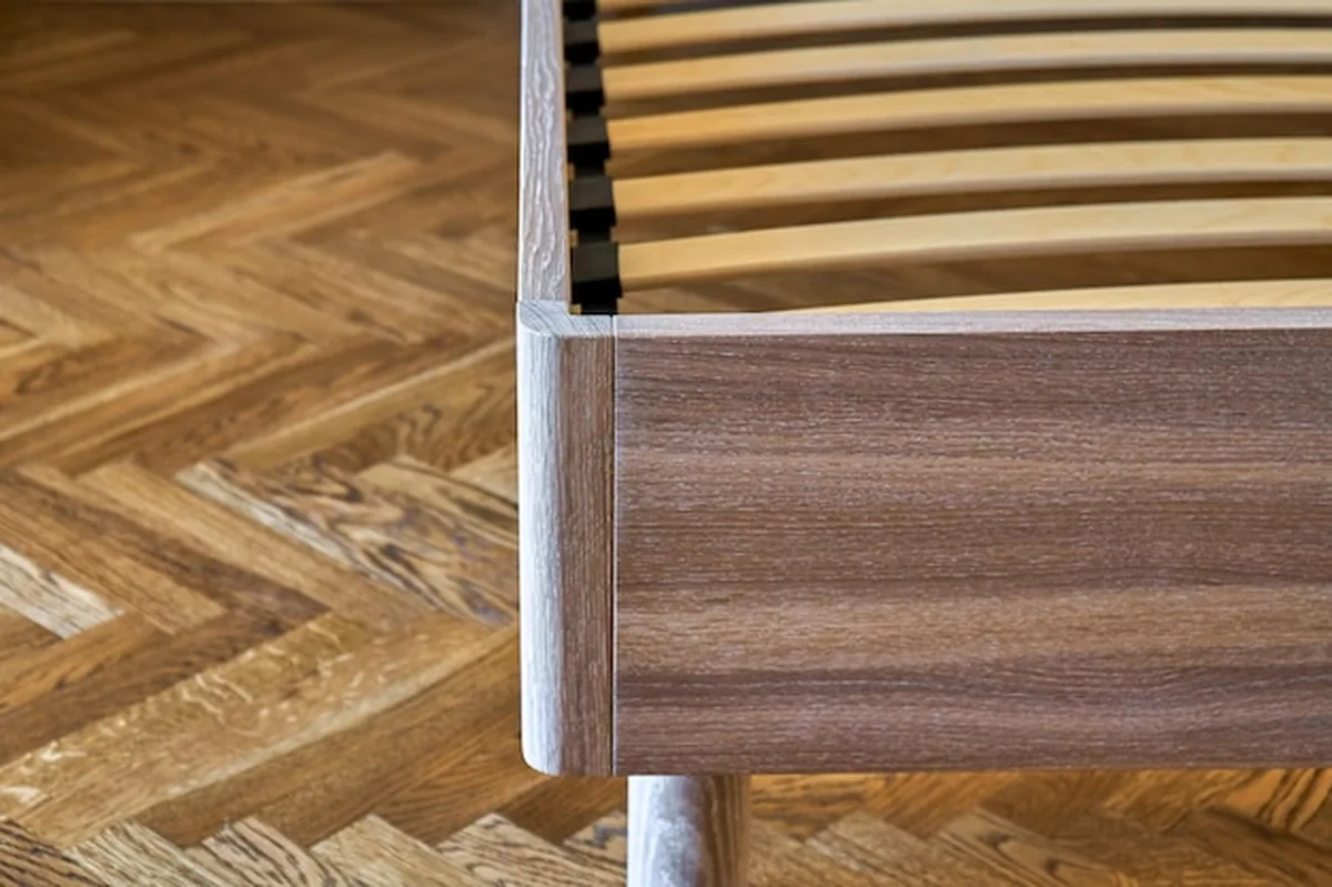 Drewniane łóżko z dębu na parkiecie w stylu skandynawskim