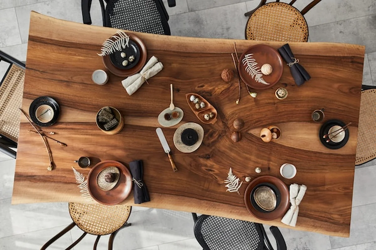 Stylowa jadalnia z drewnianym stołem orzechowym, retro krzesłami, zastawą stołową, talerzami, obiadem i dekoracjami