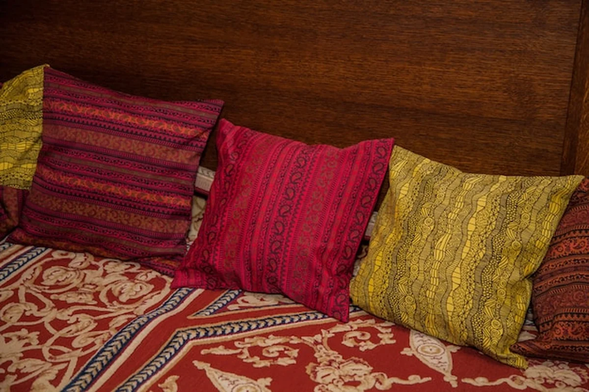 Rzeźbione łóżko w orientalnym stylu z poduszkami