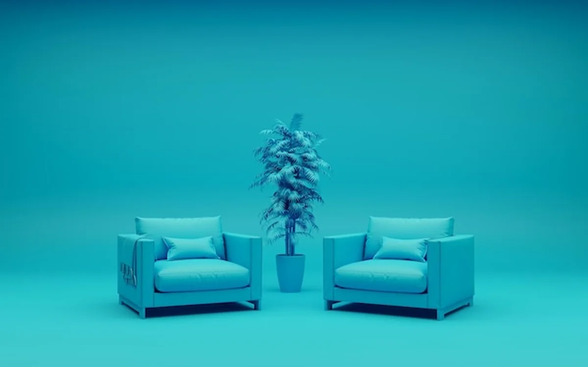 Monochromatyczne wnętrze z turkusowymi fotelami i kwiatkiem w doniczce